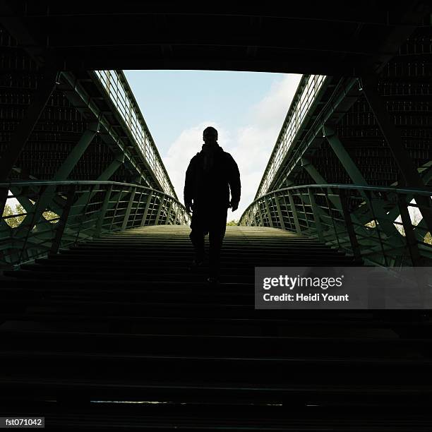 a man walking into a stadium - heidi stock-fotos und bilder