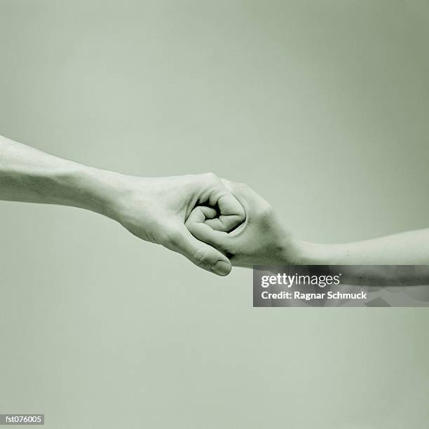 interlocked hands - intertwined stock pictures, royalty-free photos & images