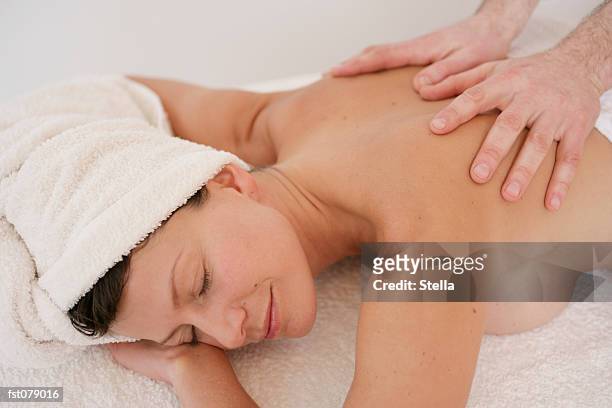 a massage therapist massaging a woman?s back - stella stock pictures, royalty-free photos & images