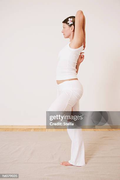 a woman in a yoga pose - stella stockfoto's en -beelden