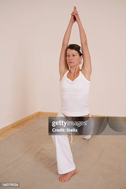 a woman in a yoga pose - stella stockfoto's en -beelden