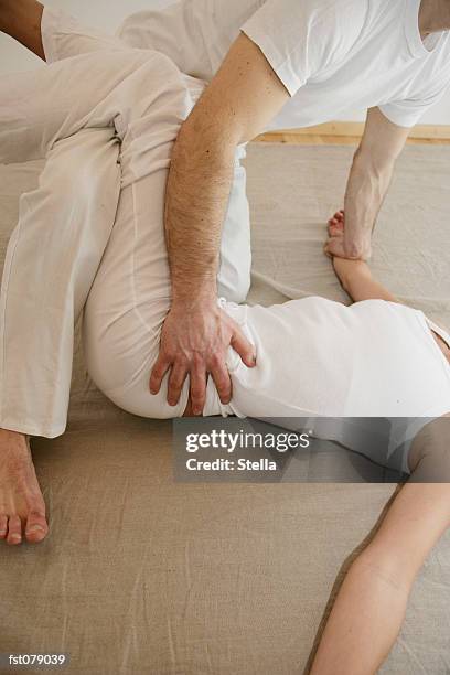 two people practicing shiatsu - stella stockfoto's en -beelden