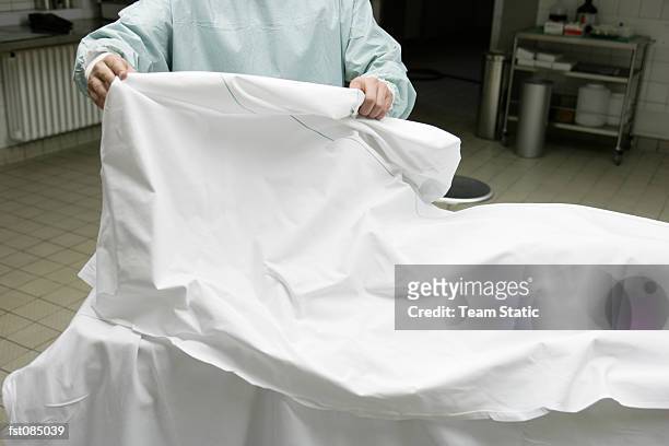 doctor removing sheet - autopsy stock pictures, royalty-free photos & images
