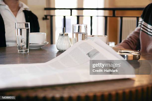 close-up of newspaper on a cafe table - sugar shaker stock pictures, royalty-free photos & images