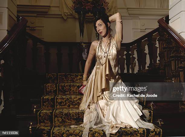 woman kneeling on stairs in evening gown - rache stock pictures, royalty-free photos & images