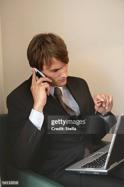 businessman with cell phone and laptop computer - stella stock pictures, royalty-free photos & images