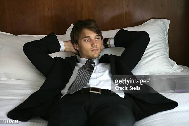 man in suit lying down - stella stock pictures, royalty-free photos & images