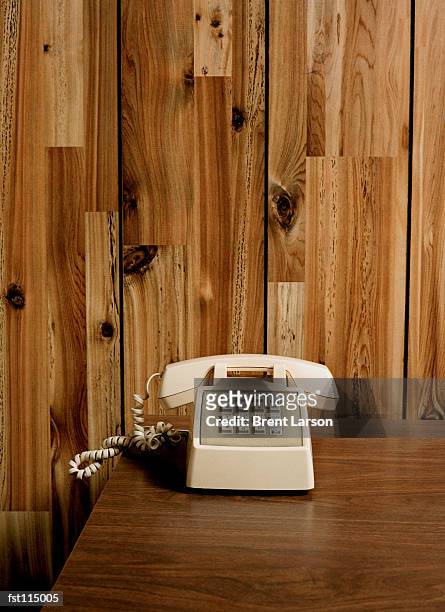 telephone on wooden table - festnetztelefon stock-fotos und bilder