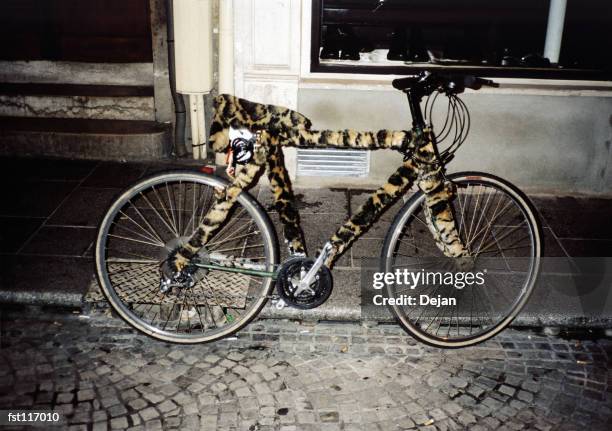 bicycle with leopard cover - curb side stock pictures, royalty-free photos & images