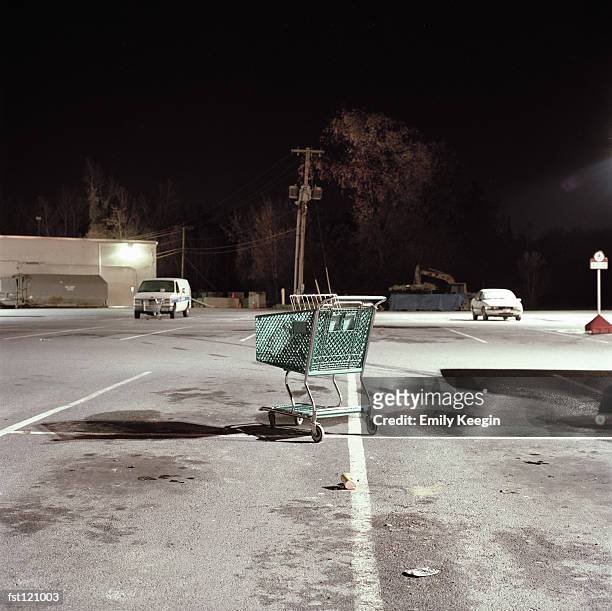 abandoned shopping cart in parking lot - abandoned cart stock pictures, royalty-free photos & images