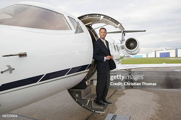 businessman standing on a private airplane?s steps - thomas's imagens e fotografias de stock