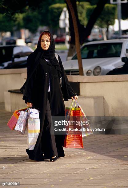 arab woman with shopping bags - shah stock-fotos und bilder