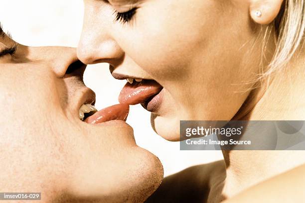 couple kissing - couple tongue kissing stock-fotos und bilder