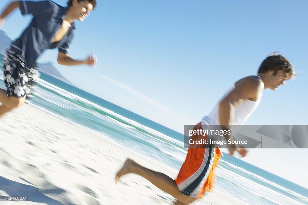 Men running on beach