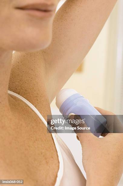 woman using deodorant - deodorant stock pictures, royalty-free photos & images