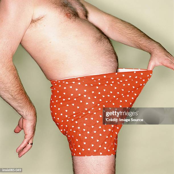 male abdomen - red shorts stock pictures, royalty-free photos & images