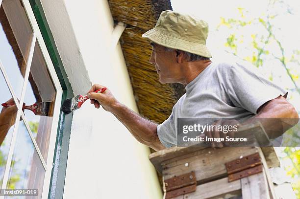 man painting house - marco de ventana fotografías e imágenes de stock