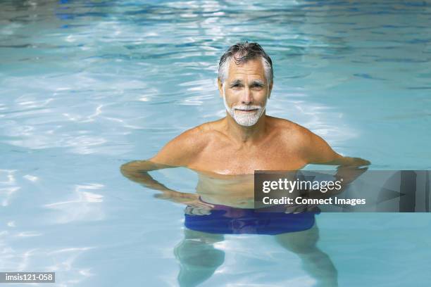 man in swimming pool - man swimming trunks stock pictures, royalty-free photos & images