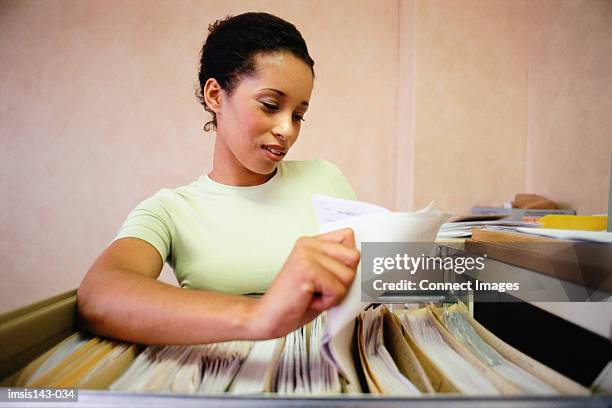 Filing Assistant Examples Woman Filing Paperwork Photos and Premium High Res Pictures - Getty Images