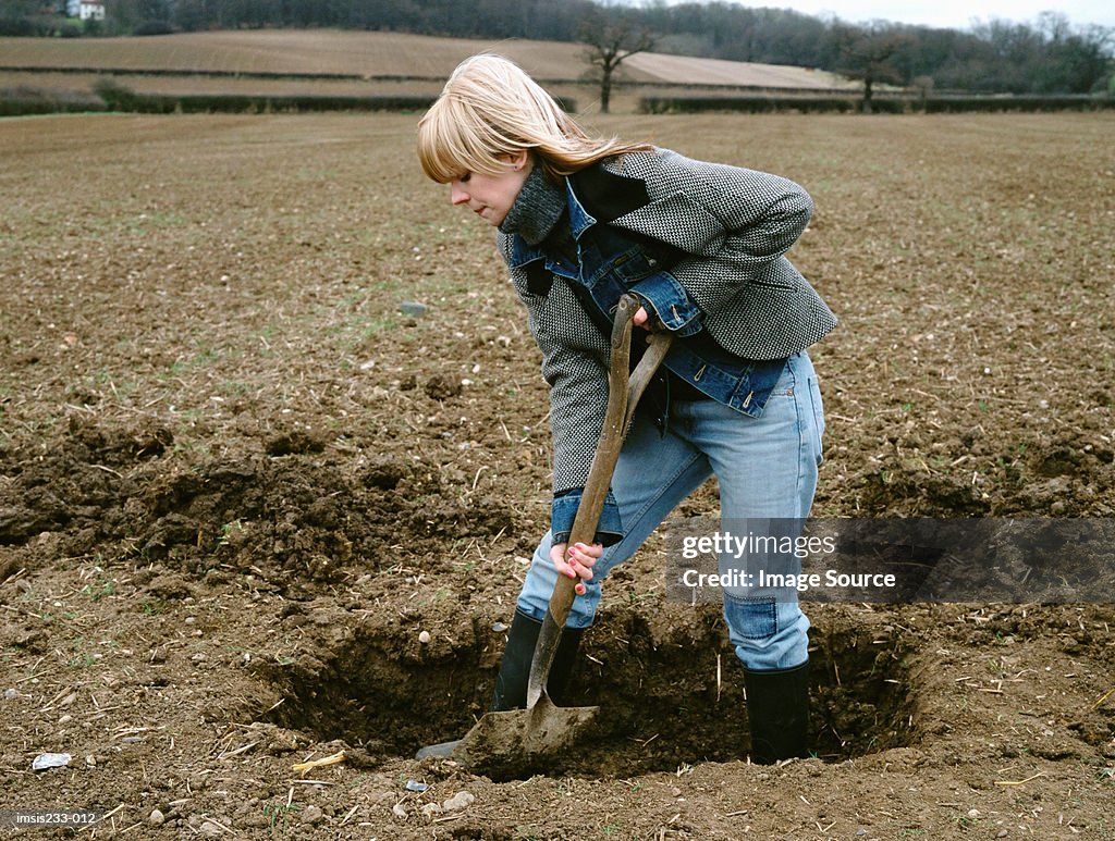 Farmer digging a hole
