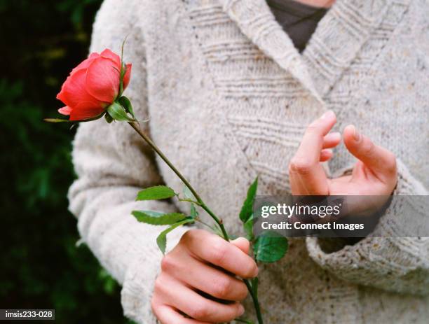 girl hurts her finger on a rose thorn - thorn stock pictures, royalty-free photos & images