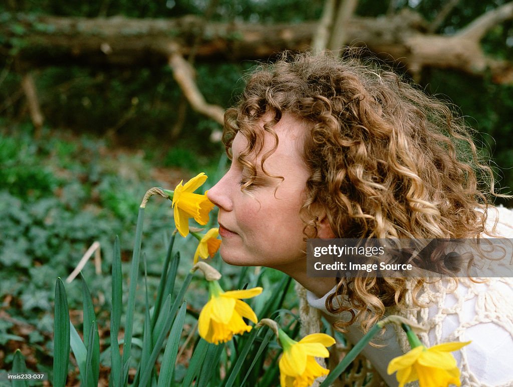 Woman smelling daffodils