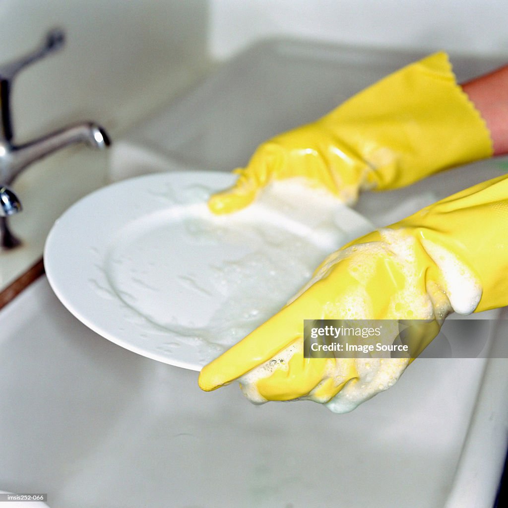 Washing up with rubber gloves