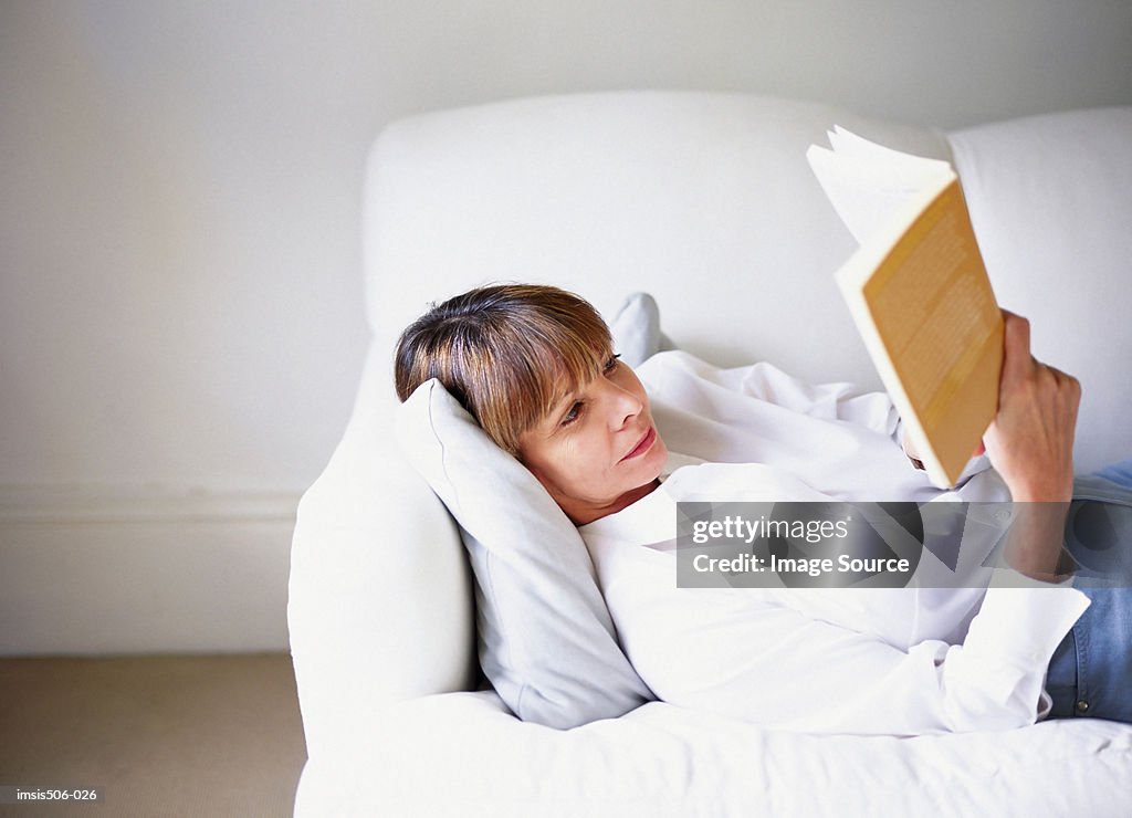 Woman reading on sofa