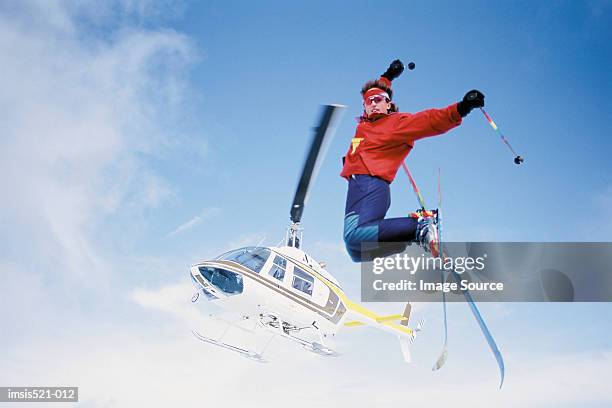 skier jumping from helicopter - skier jumping stock pictures, royalty-free photos & images