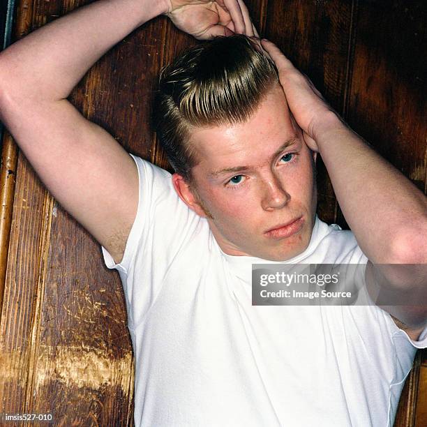 young boy combing his hair - pompadour imagens e fotografias de stock