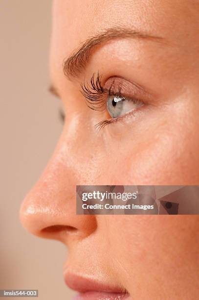 partial profile of female face - menschliche nase stock-fotos und bilder