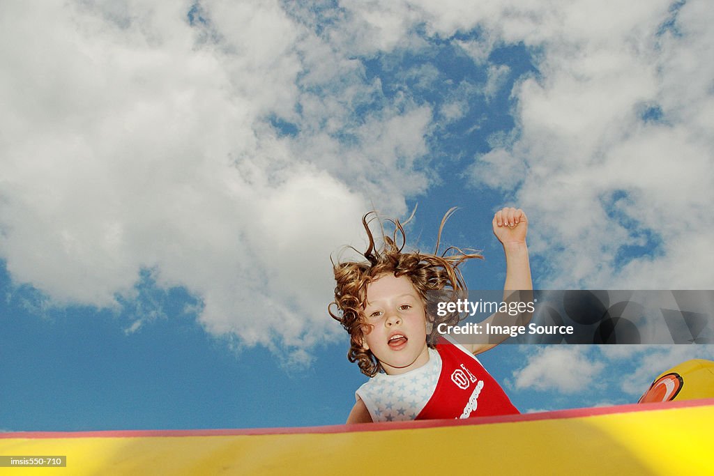 Girl jumping on bouncy castle