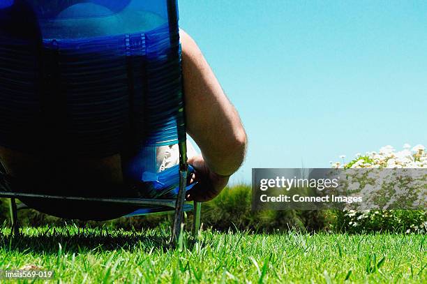 man sunbathing - fat man tanning stock pictures, royalty-free photos & images