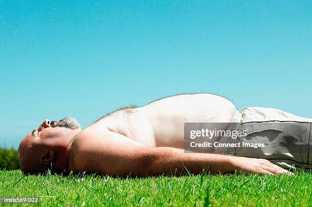 overweight man sunbathing - fat guy belly stock pictures, royalty-free photos & images