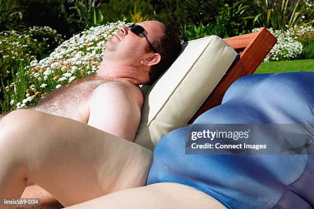 overweight couple sunbathing - fat man tanning stock pictures, royalty-free photos & images