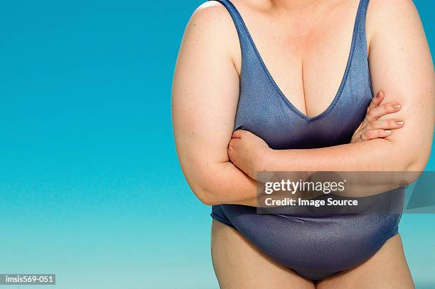 overweight woman in swim suit - bierbauch stock-fotos und bilder