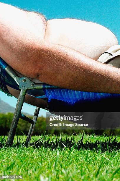 overweight man sunbathing - fat man tanning stock pictures, royalty-free photos & images