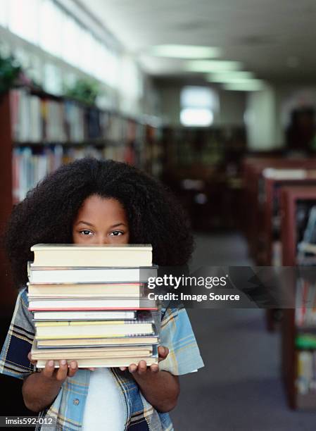 boy holding stack of books - text book stock pictures, royalty-free photos & images