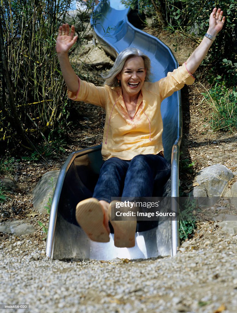 Laughing woman on slide.