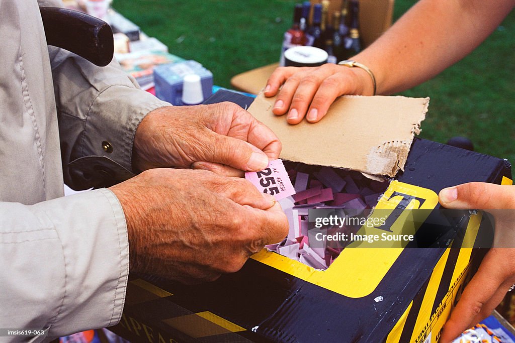 Man holding raffle ticket