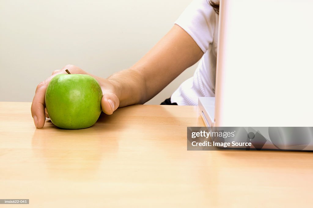 Businessman holding an apple