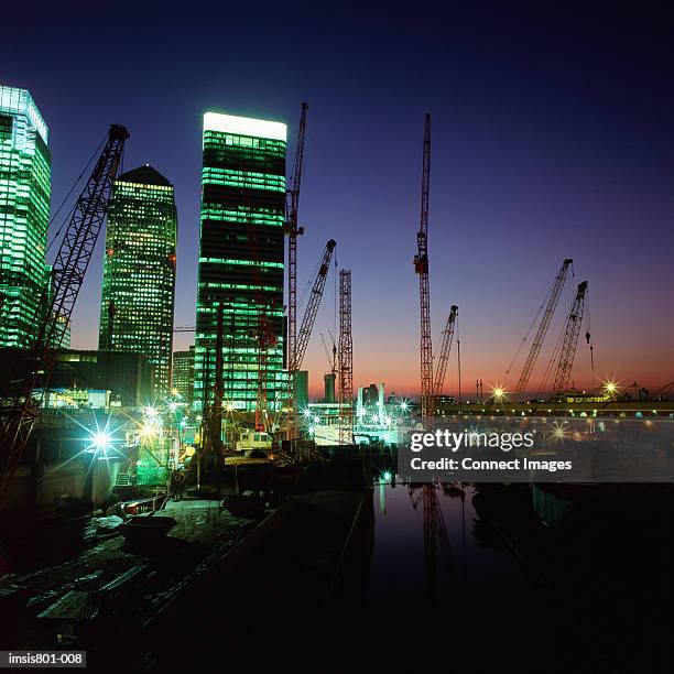 canary wharf and cranes on thames - canary wharf square stock pictures, royalty-free photos & images