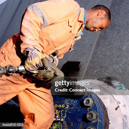Construction worker using pneumatic drill Construction worker using pneumatic drill