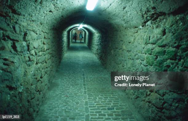 catacombs beneath dalt vila, old walled town. - vila stock pictures, royalty-free photos & images