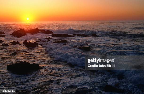 sunset over pacific ocean, monterey bay, united states of america - pacific war stock-fotos und bilder