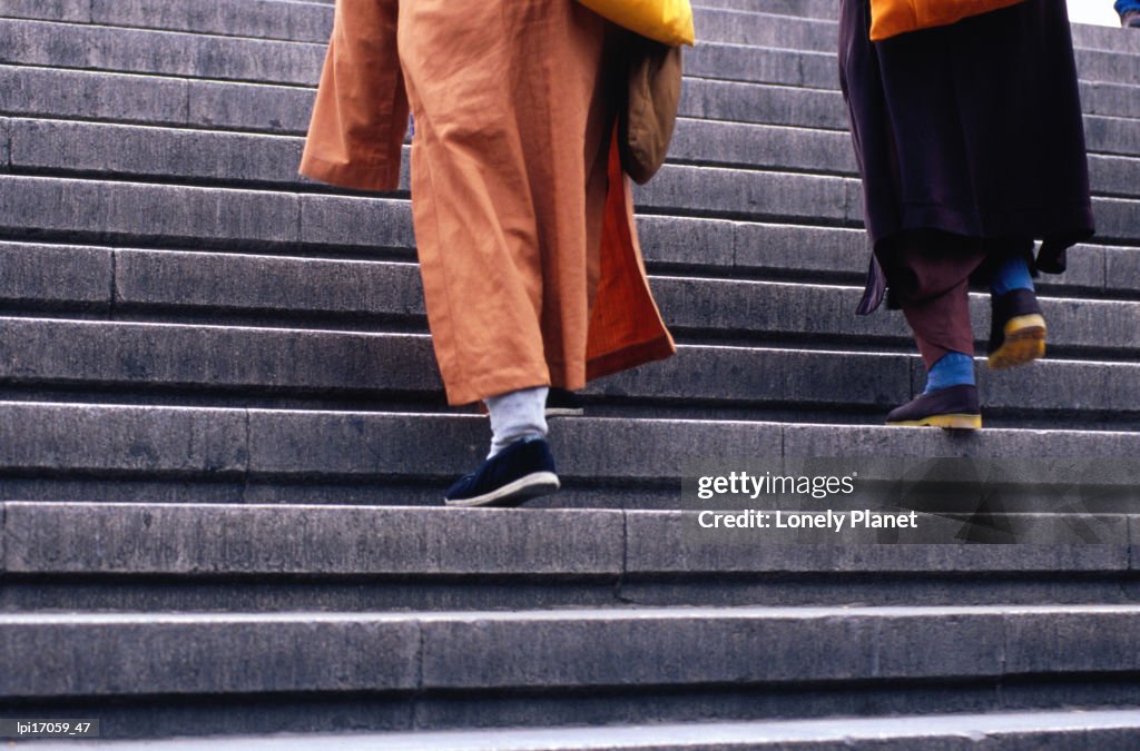 Monks ascending stairs in Dongcheng district.