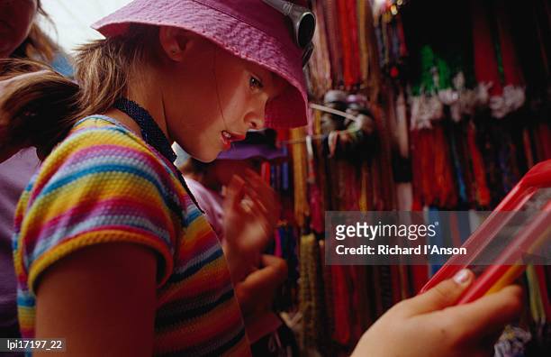 girl shopping for glass bead necklaces at indra chowk, kathmandu, nepal - kathmandu valley stock pictures, royalty-free photos & images