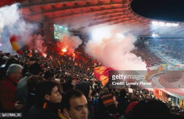 flares in curva sud stand at champions league game stadio olimpico, rome, italy - stadio stock-fotos und bilder
