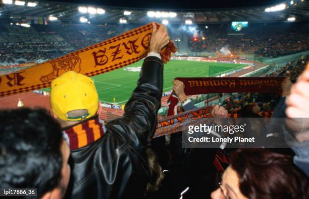 soccer fans waving as roma scarves at as roma vs ajax amsterdam match at champions league game stadio olimpico, rome, italy - stadio stock-fotos und bilder