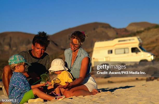 family playing on beach, cabo san lucas, mexico - cabo stock pictures, royalty-free photos & images